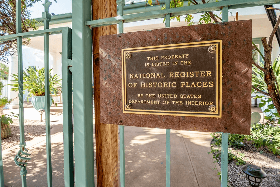 A bronze plaque indicating the property is listed on the National Register of Historic Places.